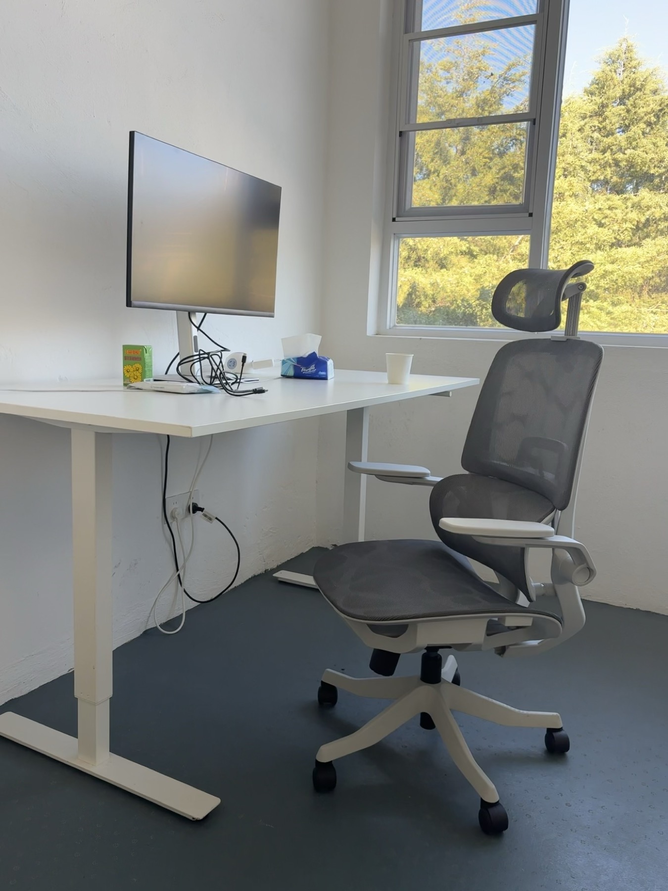 Dedicated desk with monitor and ergonomic chair